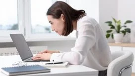 postura Donna lavora seduta alla scrivania con postura scorretta